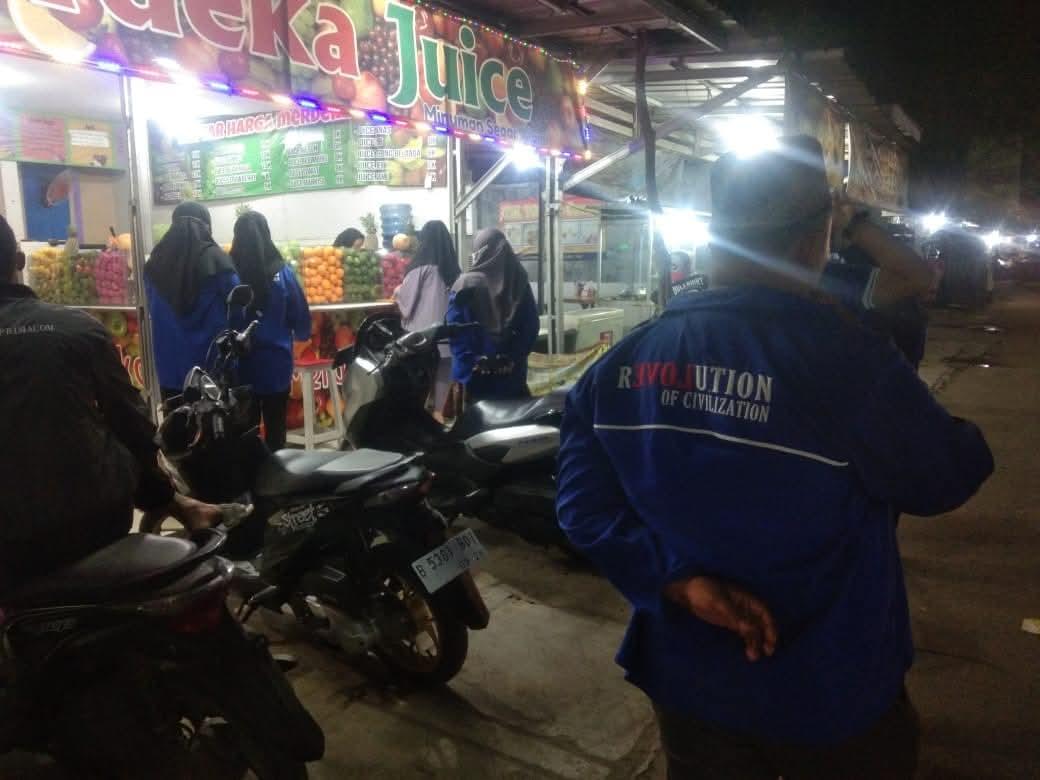 Members in ROC jackets at an evening street outreach