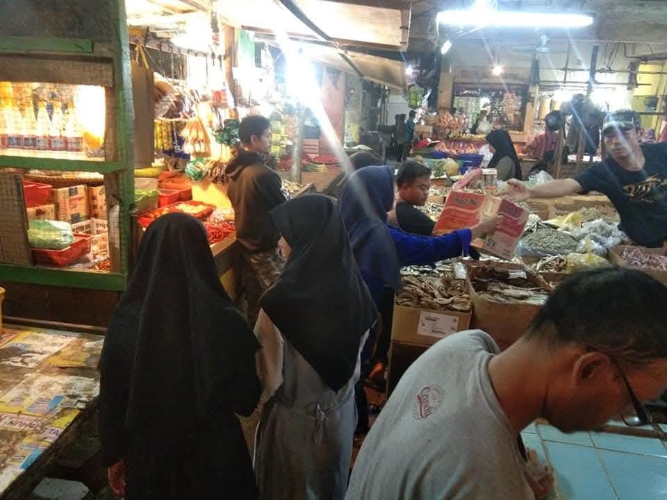 Members shopping at a traditional market for supplies