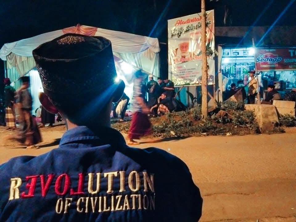 Member in ROC jacket at an evening community event