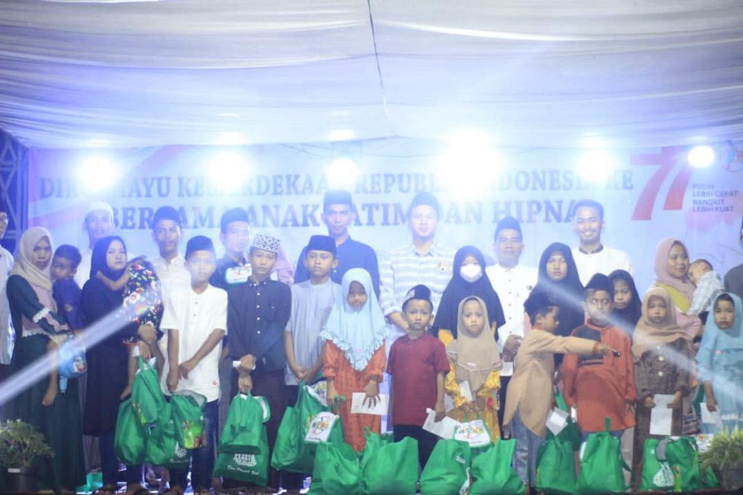 Group photo with orphaned children holding donation bags